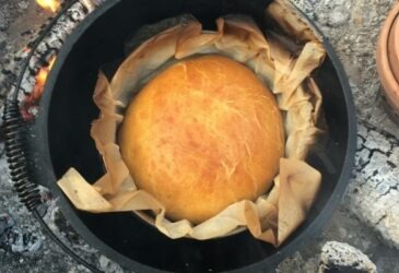 bread in the dutch oven still on the campfire