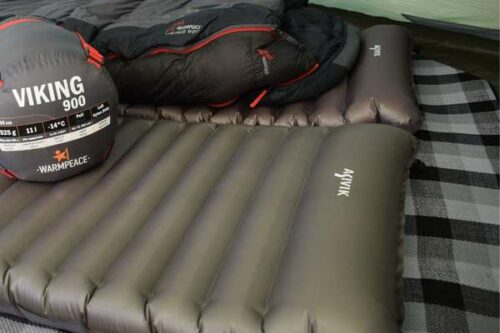 two sleeping pads with insulation blanket underneeth and sleeping bags on top.