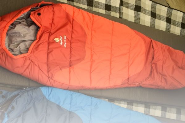 the deuter toddler sleeping bag rolled out in a tent