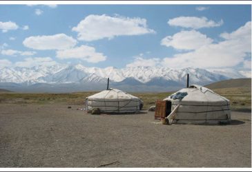 two yurts in the vast space of rural Mongolia with a big blue skye and lots of clouds